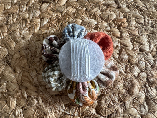 Dog collar flower, mixed autumn fabrics, showing the elastic on the back